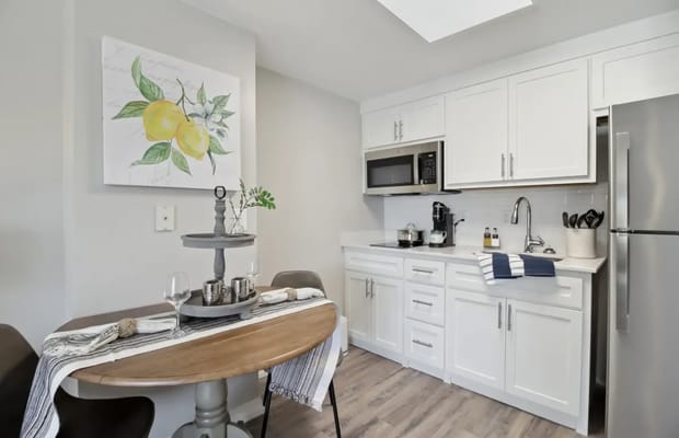 Modern kitchen with dining table and lemon art