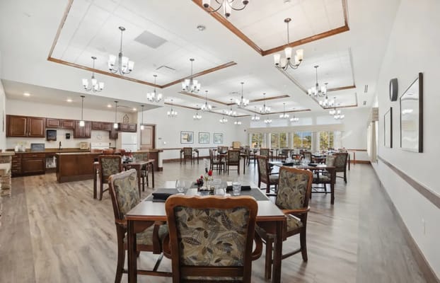 Bright dining area with large windows and chandeliers