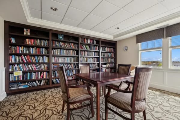 Cozy library with bookshelves and seating area