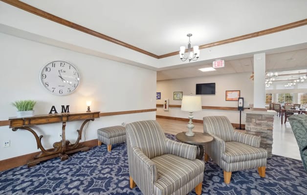 Cozy lounge area with seating and clock