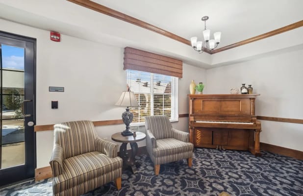Cozy common area with seating and a piano