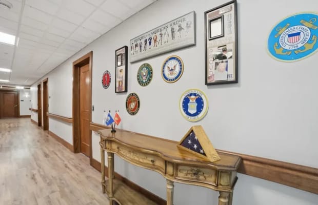 Decorative hallway with military awards and photos