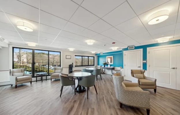 Bright common area with seating and large windows