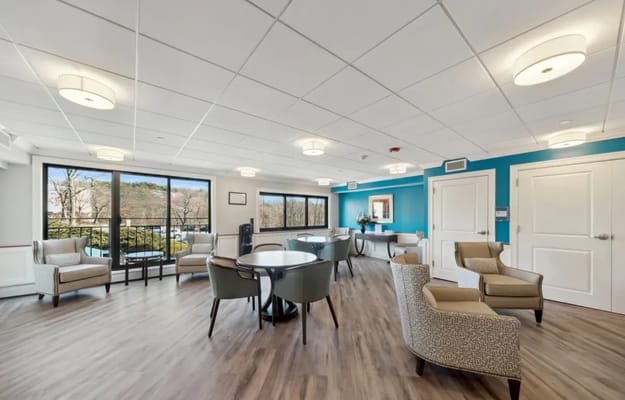 Bright common area with seating and large windows