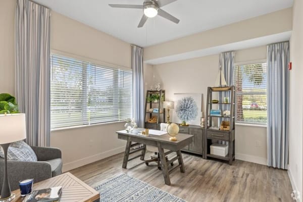 Bright, inviting interior space with a desk and windows