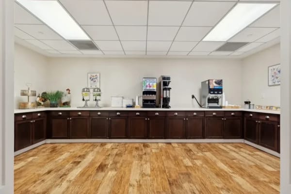 Interior view of a facility dining area with coffee station
