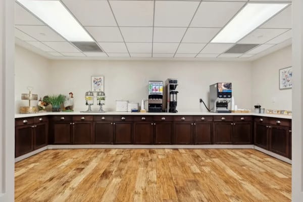 Interior view of a facility dining area with coffee station