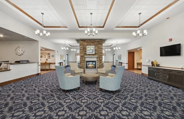Bright common area with cozy seating and a fireplace