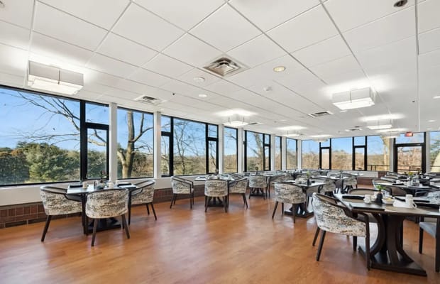 Bright dining room with large windows and tables