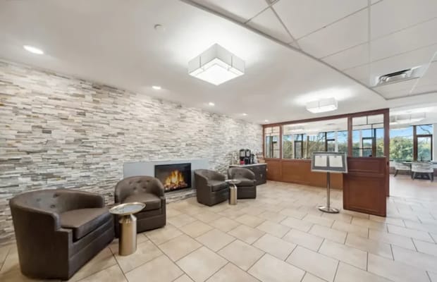 A cozy lounge area with seating and a fireplace