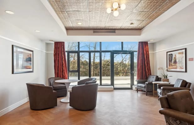 Bright common area with seating and large windows