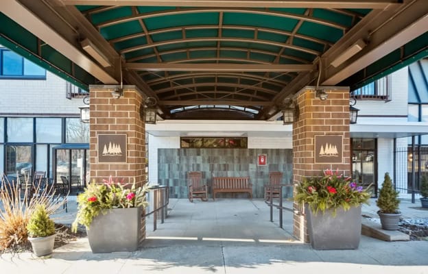 Entrance of a senior living facility with outdoor seating