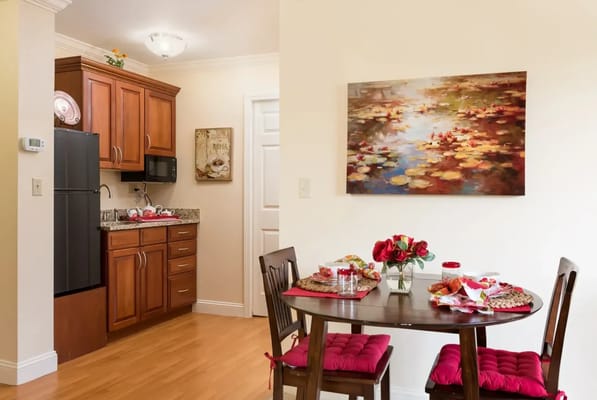 Cozy dining area with table and kitchen in view