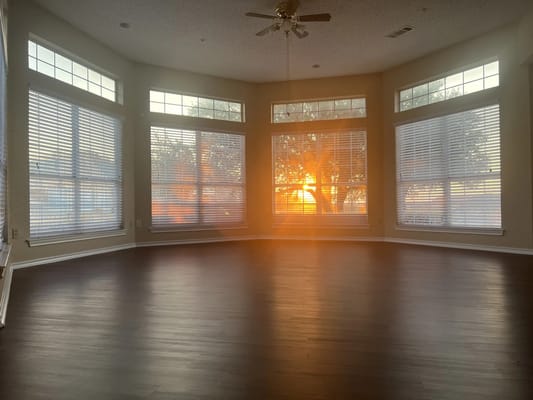 Sunset view from large windows in a bright room