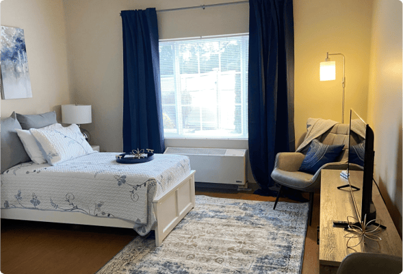 Cozy private resident room with bed and seating area