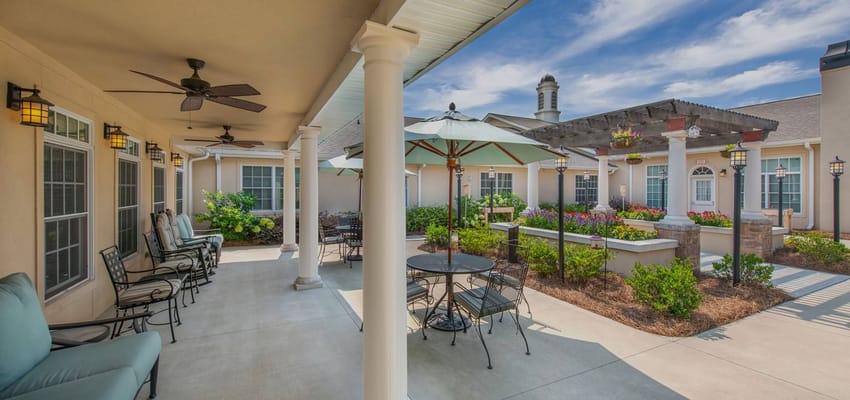 Outdoor patio area with seating and landscaping