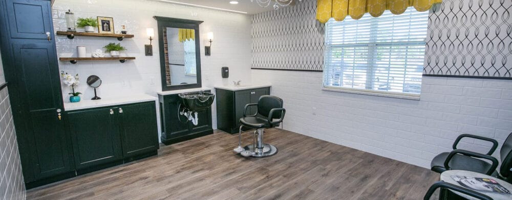 Bright salon area with styling chair and decor