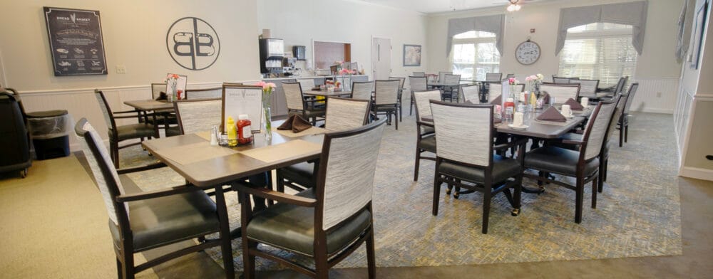 Dining area with tables and chairs set for meals
