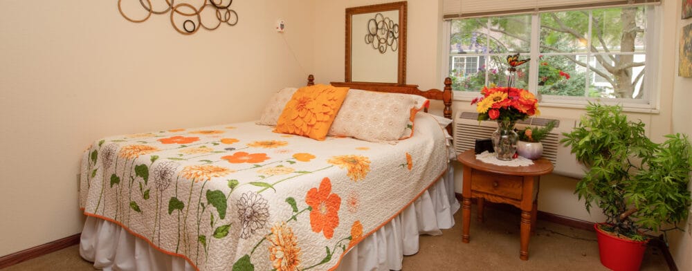 Cozy resident room with floral decor and window view