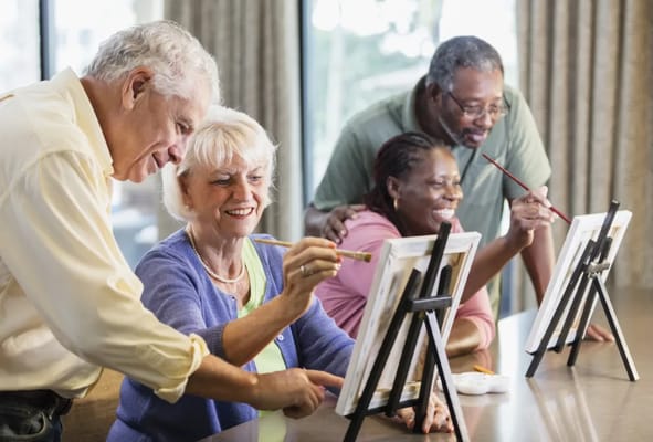 Residents enjoying a painting activity in a common area