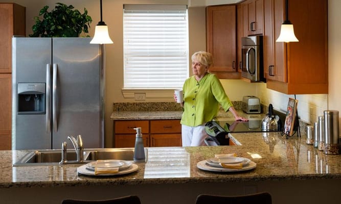 Woman enjoying coffee in a modern kitchen