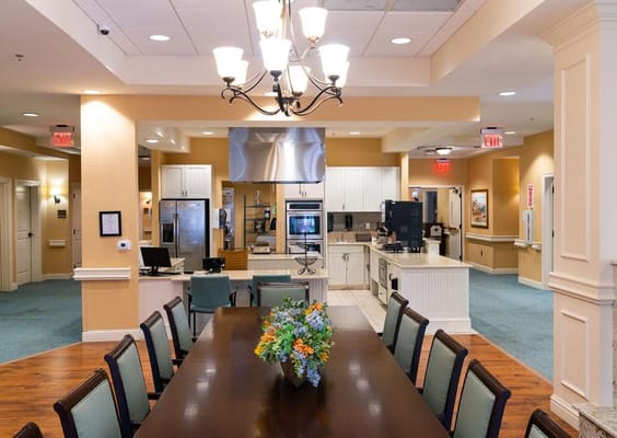 Bright dining area with a long table and floral centerpiece