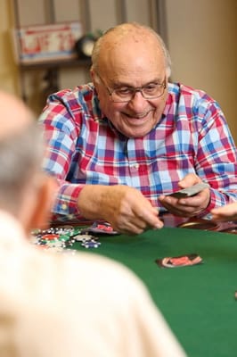 Resident enjoying a poker game with friends