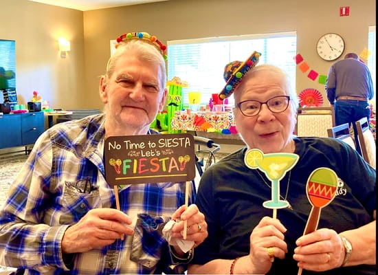 Residents enjoying a fiesta-themed activity with props