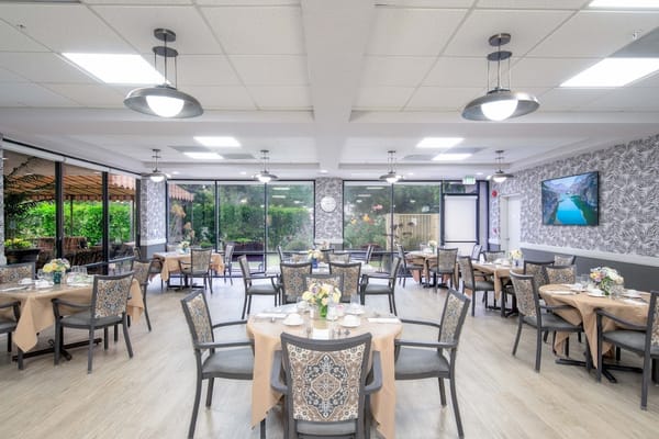 Bright dining room with tables set for meals