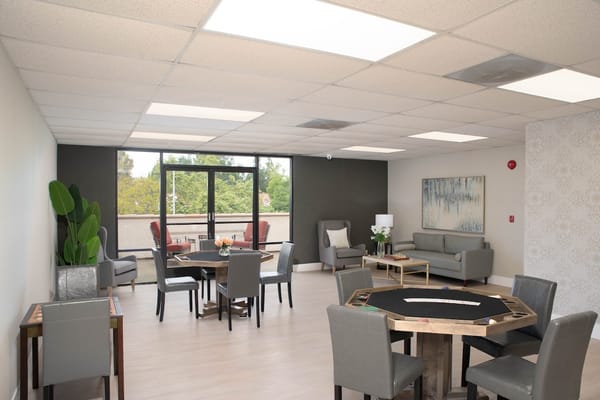 Bright activity room with tables and chairs
