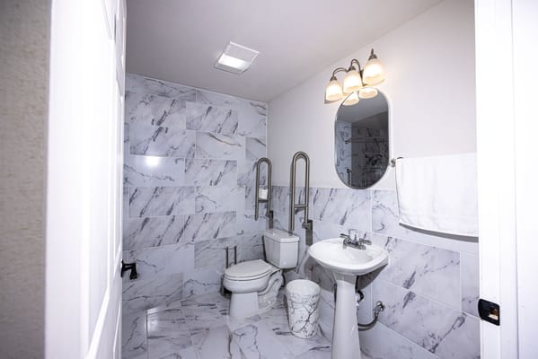 Clean bathroom with marble walls and modern fixtures