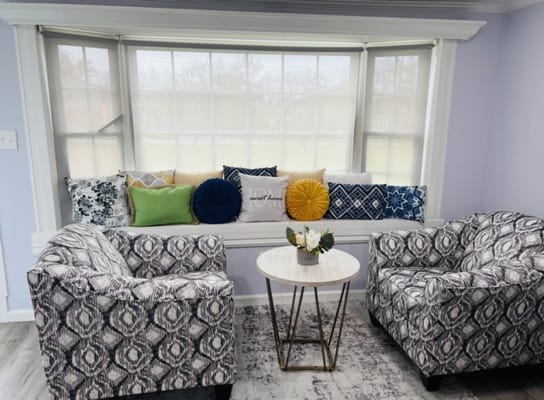 Cozy sitting area with patterned chairs and colorful cushions