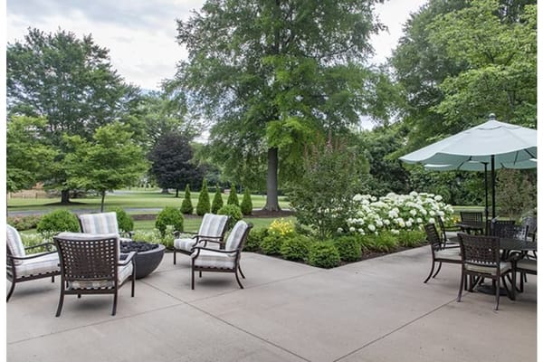 Outdoor patio area with seating and greenery