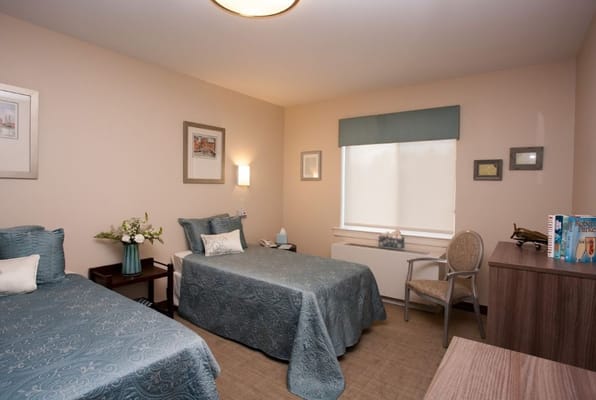 Comfortable resident room with two beds and decor