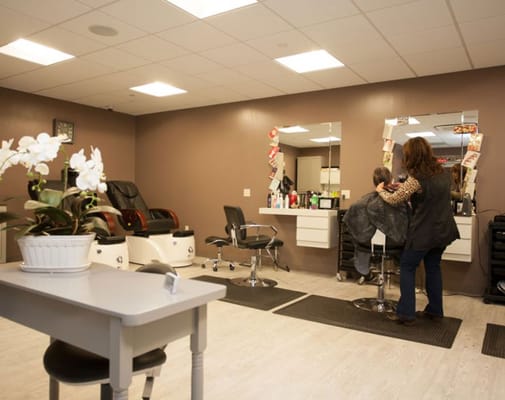A resident receiving hair service in the salon