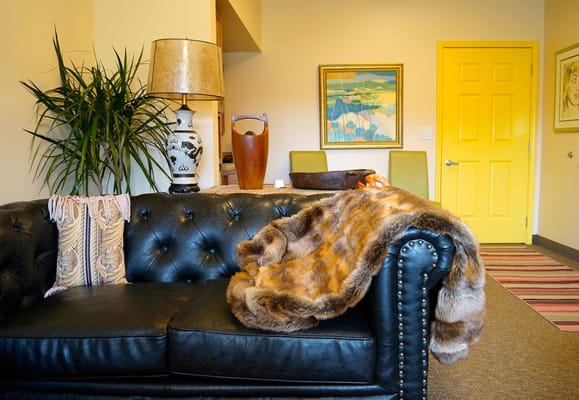 Comfortable black sofa in a living room with decorative elements.