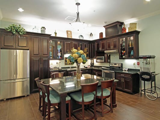 Bright kitchen area with dining table and modern appliances