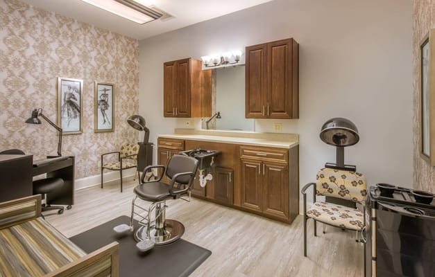 Hair salon area with styling chairs and mirrors