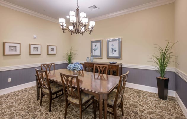 Dining room with a large wooden table and floral decor