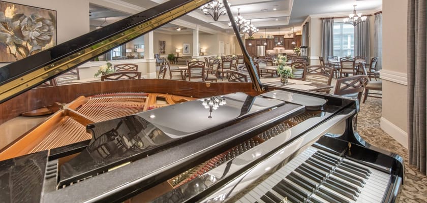 Interior view featuring a grand piano and dining area