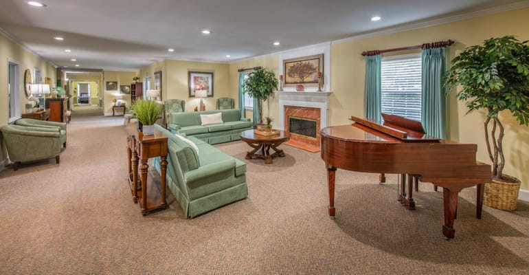 Spacious common area with seating and a piano
