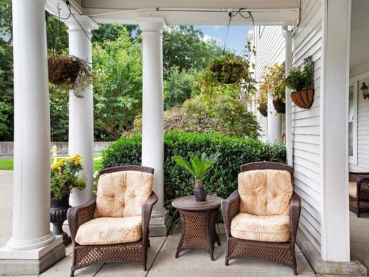 Outdoor seating area with comfortable chairs and greenery