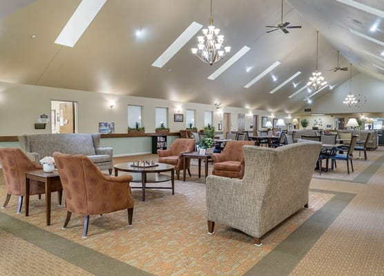 Bright common area with seating and large windows