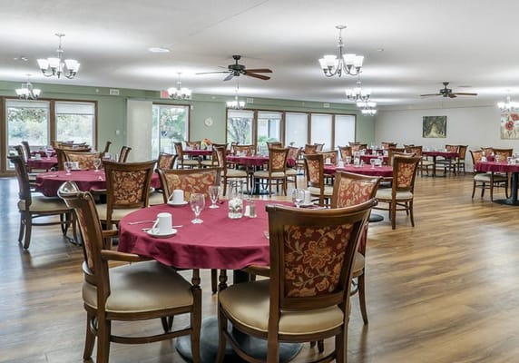 Bright dining room with tables set for meals