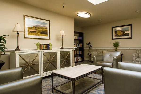 Bright common area with seating and bookshelves