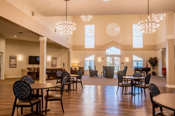 Bright common area with seating and chandeliers