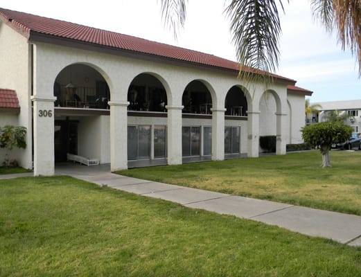 Front view of Casa El Cajon senior living facility with arches and landscaping