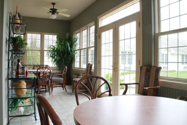 Bright common area with large windows and seating