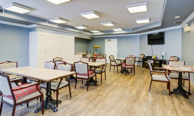 Common area with tables and chairs for residents