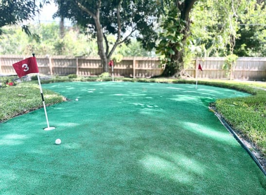 Mini golf area with putting greens and flags
